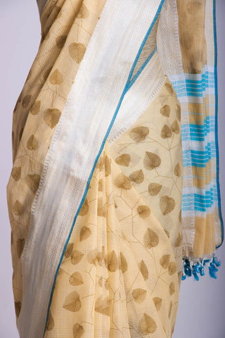 Pale yellow mangalagiri cotton saree with leaves handprint.