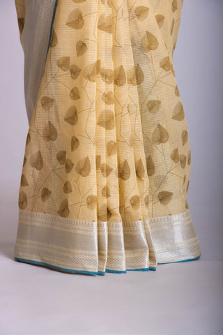 Pale yellow mangalagiri cotton saree with leaves handprint.