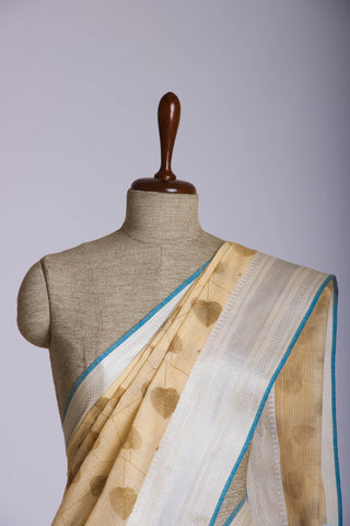 Pale yellow mangalagiri cotton saree with leaves handprint.