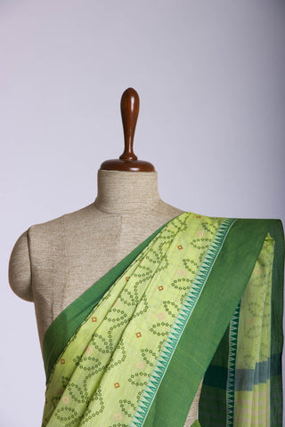 Kollam Cotton saree with lime green hand printed with Bandhani patterned design.